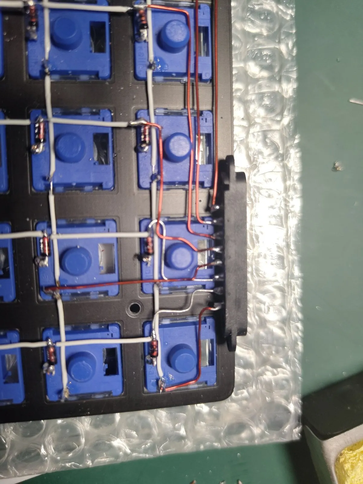 Close-up β diode at each switch, white grid, red runs heading for the connector